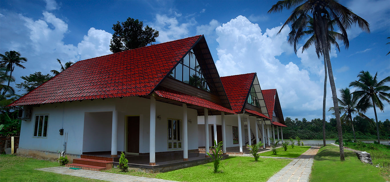 Row of cottages with verandas facing a lawn